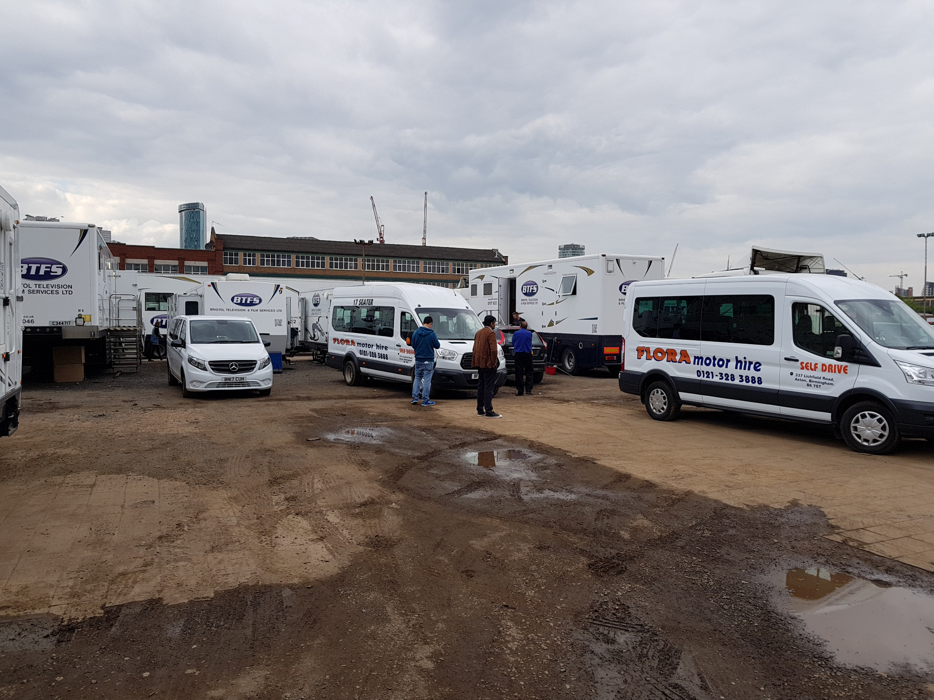 Production unit base — facility trucks and crew minibuses staged
